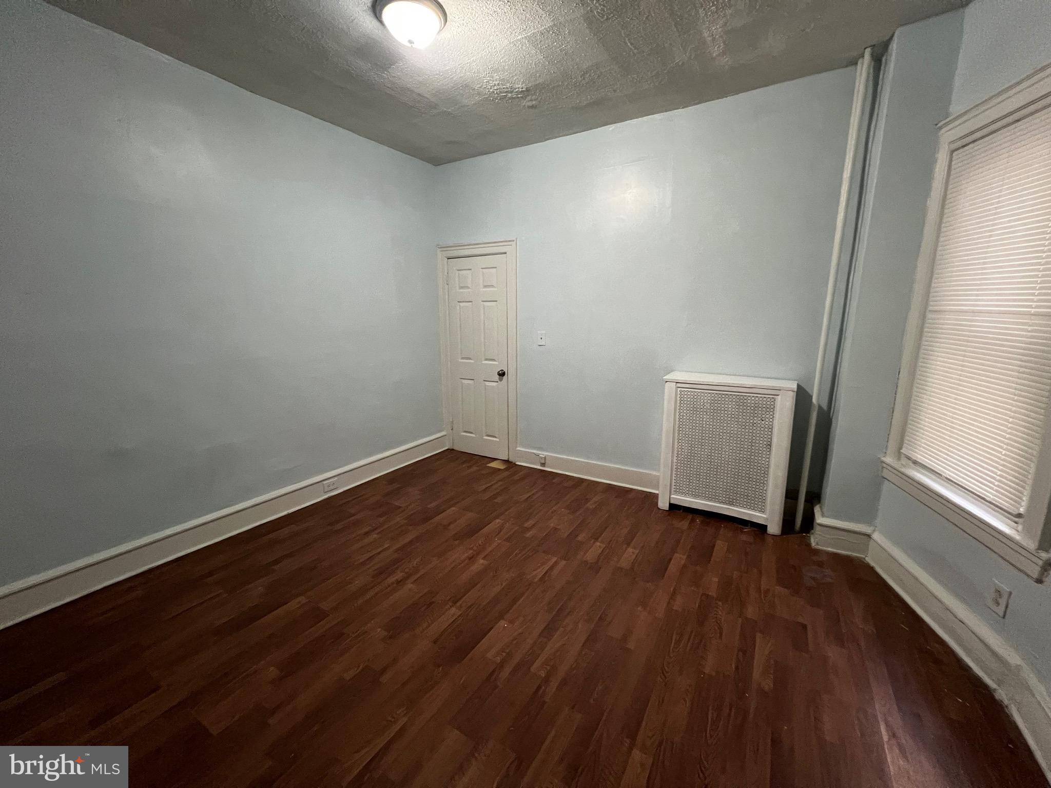 5533 Walnut Street, Unit 1 Philadelphia, PA 19139 - Photo 9 of 20 wooden floor in an empty room with a window