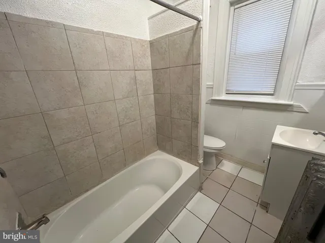 a bathroom with a bathtub and a toilet