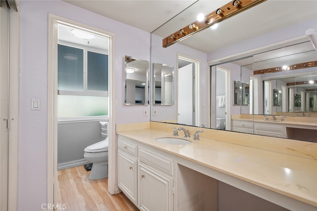 15241 Lille Circle Irvine, CA 92604 - Photo 19 of 38 a spacious bathroom with a sink a toilet a mirror and shower