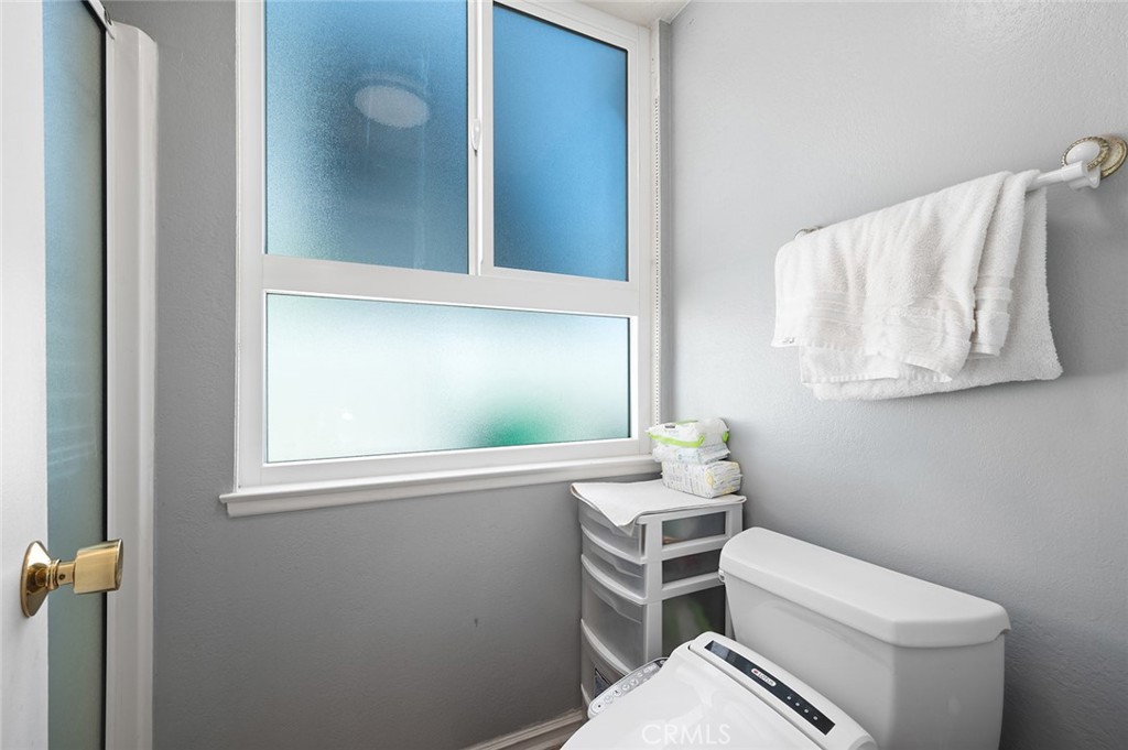 15241 Lille Circle Irvine, CA 92604 - Photo 20 of 38 a bathroom with a toilet sink and mirror