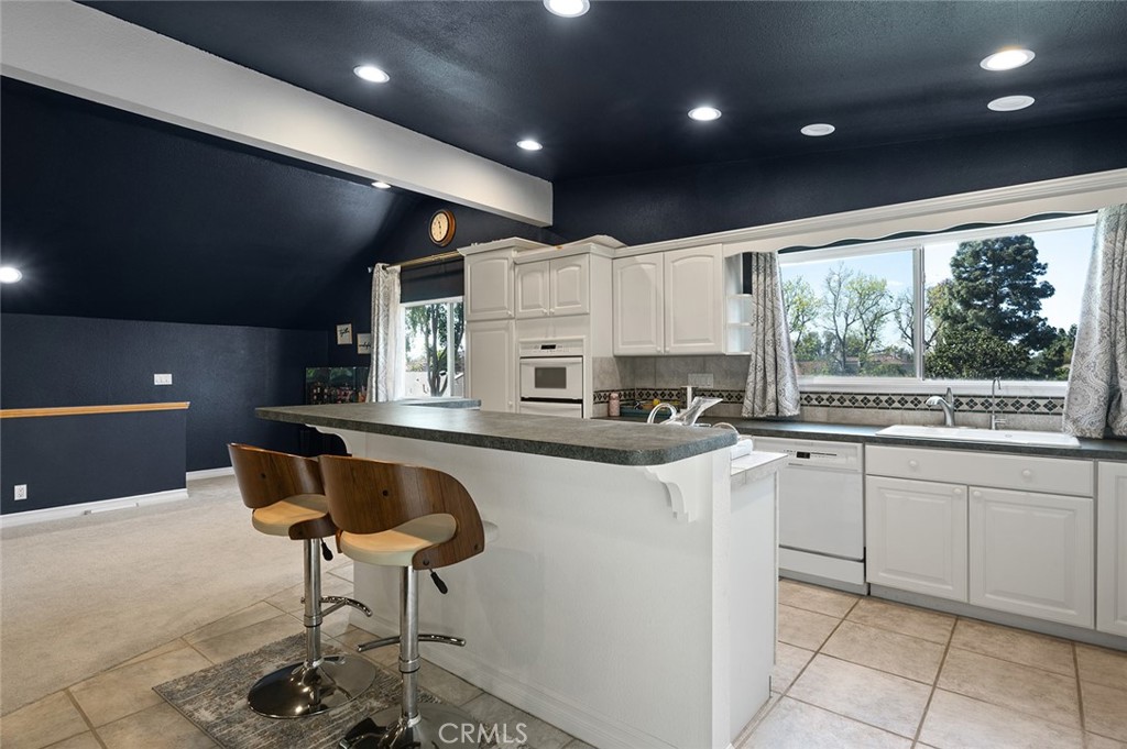 15241 Lille Circle Irvine, CA 92604 - Photo 25 of 38 a kitchen with stainless steel appliances granite countertop a stove a sink dishwasher and a refrigerator