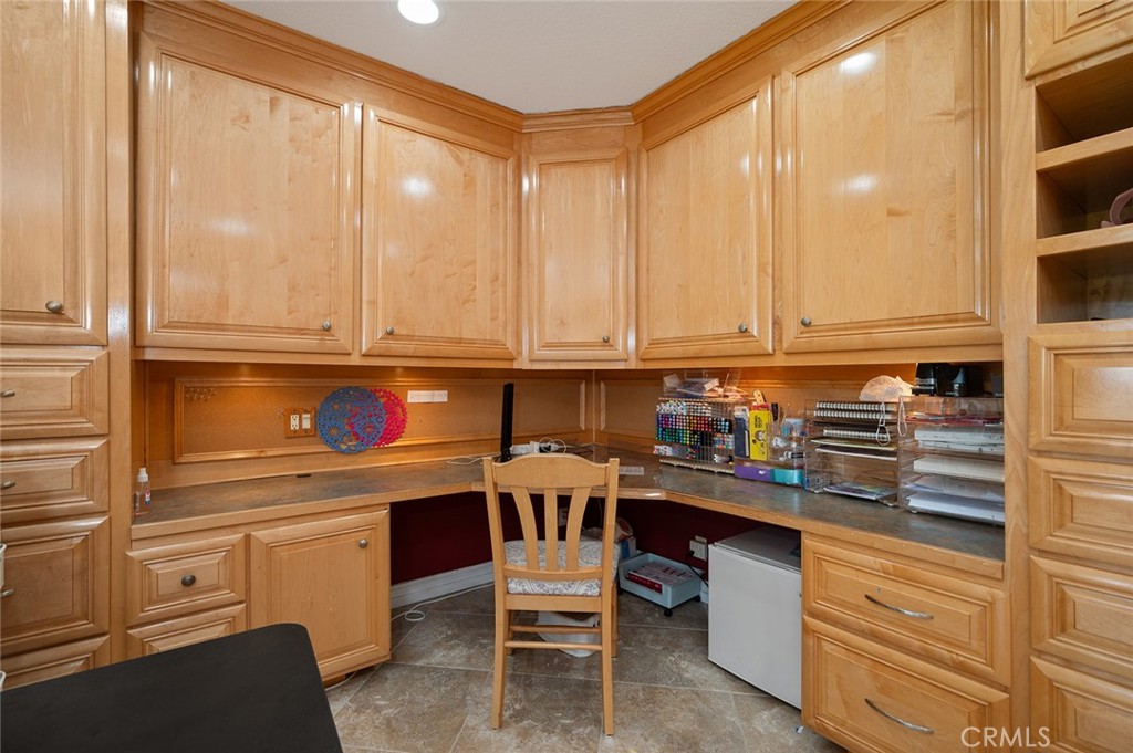 15241 Lille Circle Irvine, CA 92604 - Photo 9 of 38 a kitchen with a white cabinets and chairs