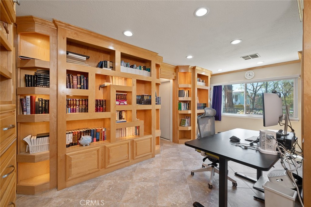 15241 Lille Circle Irvine, CA 92604 - Photo 10 of 38 a living room with furniture and a bookshelf