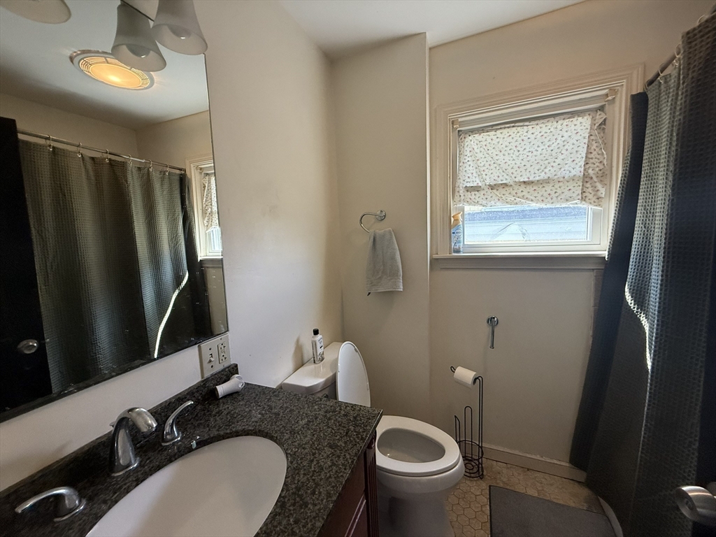 4 Barstow Street Boston, MA 02134 - Photo 11 of 21 a bathroom with a granite countertop sink toilet and a mirror