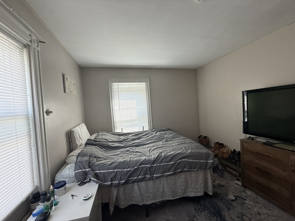 4 Barstow Street Boston, MA 02134 - Photo 15 of 21 a bedroom with a bed and flat screen tv