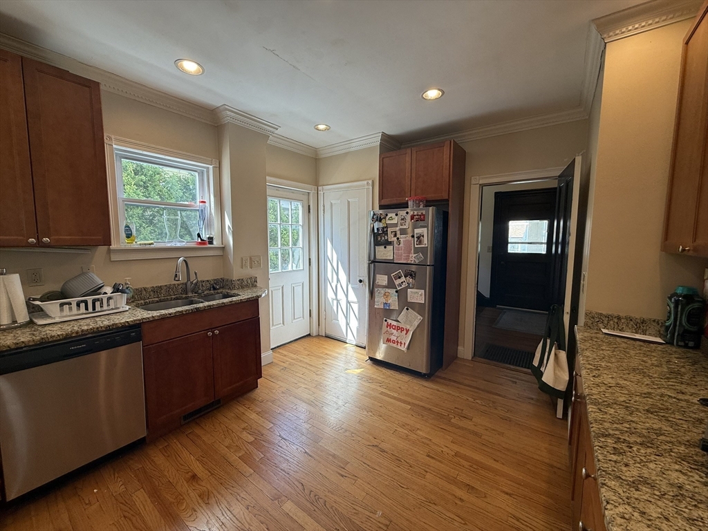 4 Barstow Street Boston, MA 02134 - Photo 4 of 21 a kitchen with stainless steel appliances granite countertop a refrigerator and a sink