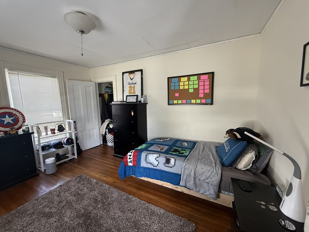4 Barstow Street Boston, MA 02134 - Photo 9 of 21 a bedroom with a bed and wooden floor