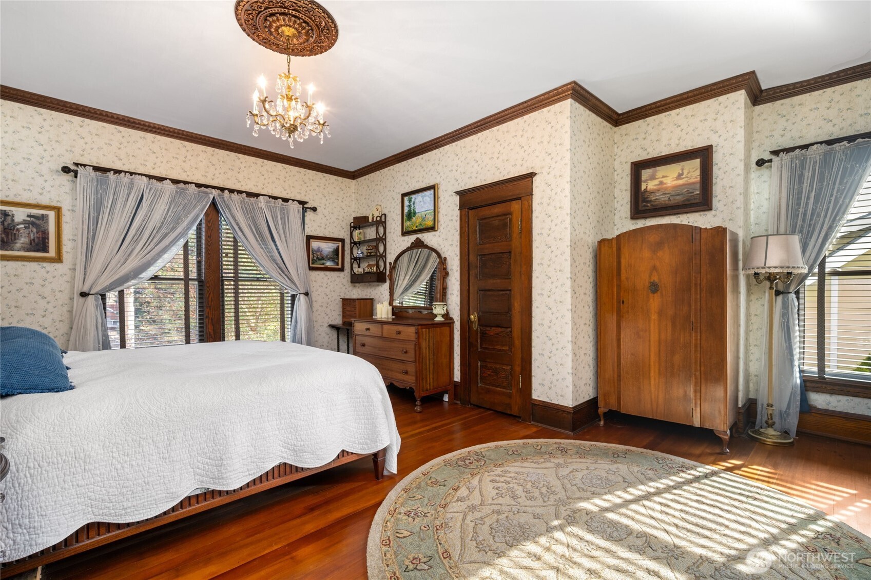 1507 15th Street Anacortes, WA 98221 - Photo 13 of 40 a bedroom with bed and a chandelier