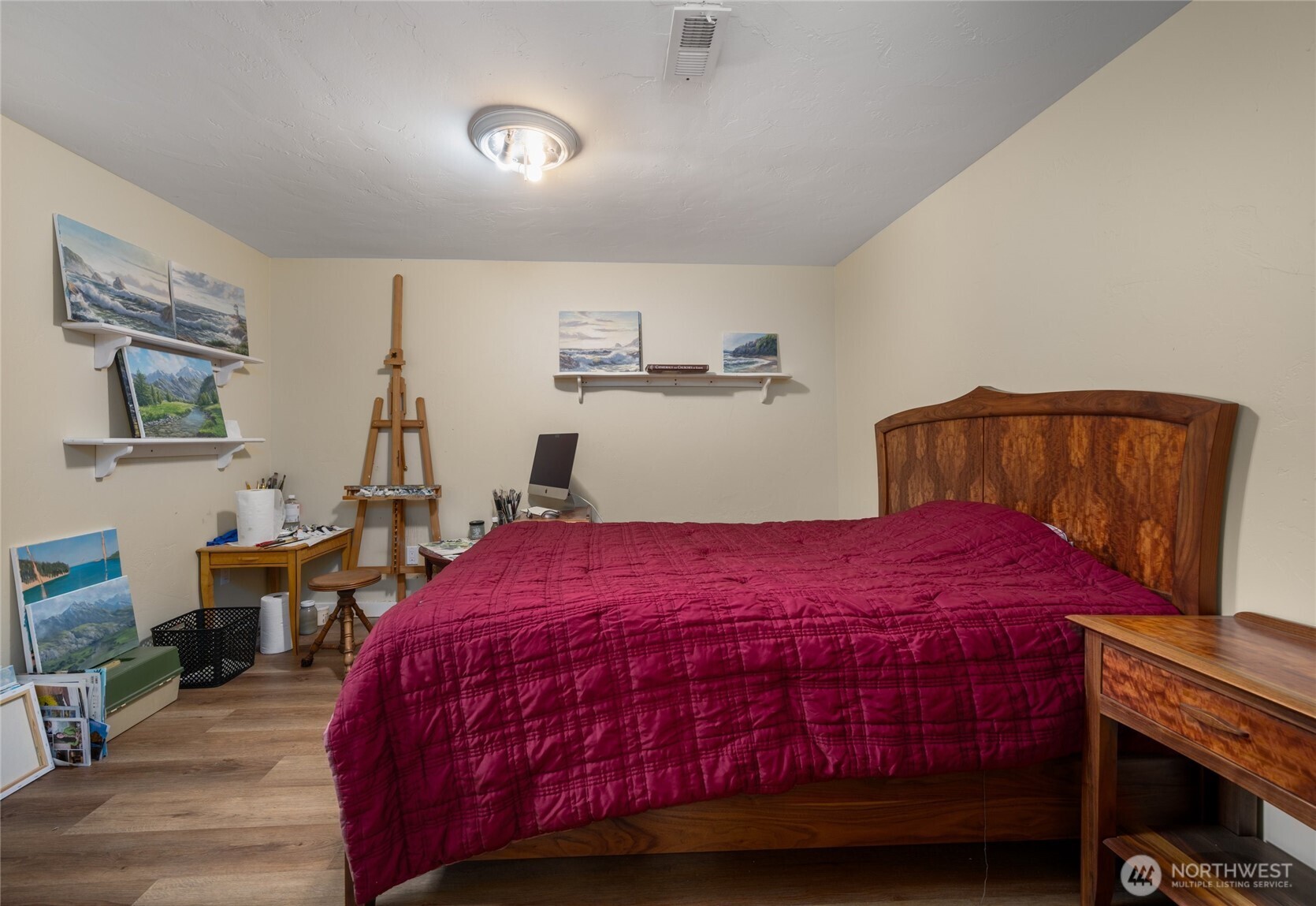 1507 15th Street Anacortes, WA 98221 - Photo 16 of 40 a bedroom with a bed and a potted plant on the dresser
