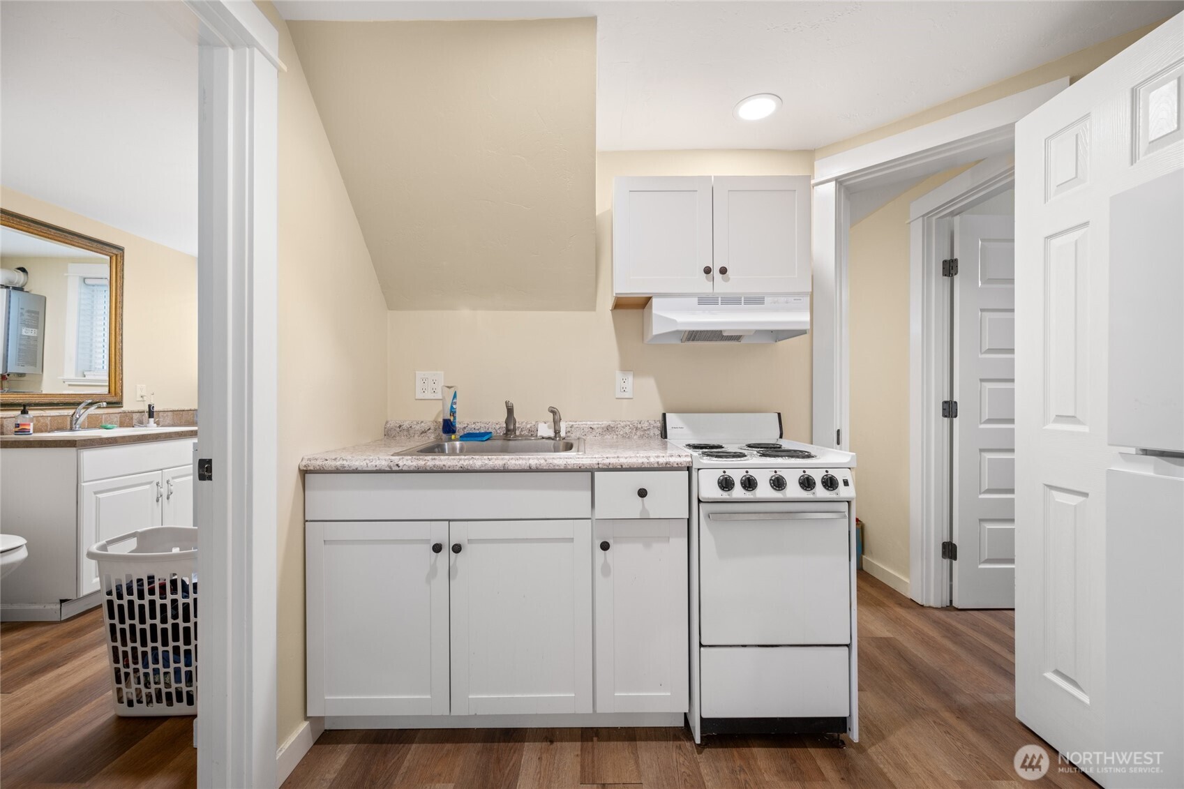 1507 15th Street Anacortes, WA 98221 - Photo 18 of 40 a kitchen with white cabinets and appliances