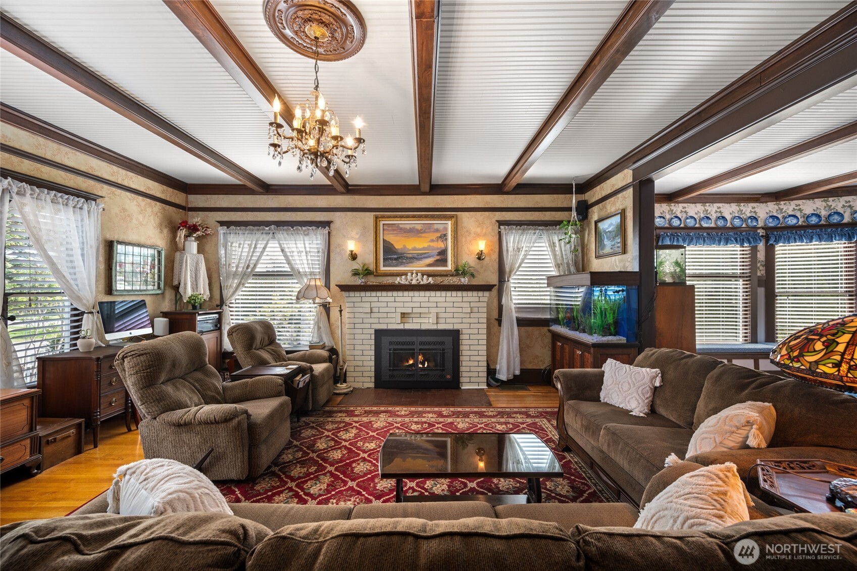 1507 15th Street Anacortes, WA 98221 - Photo 5 of 40 a living room with furniture a fireplace and a chandelier
