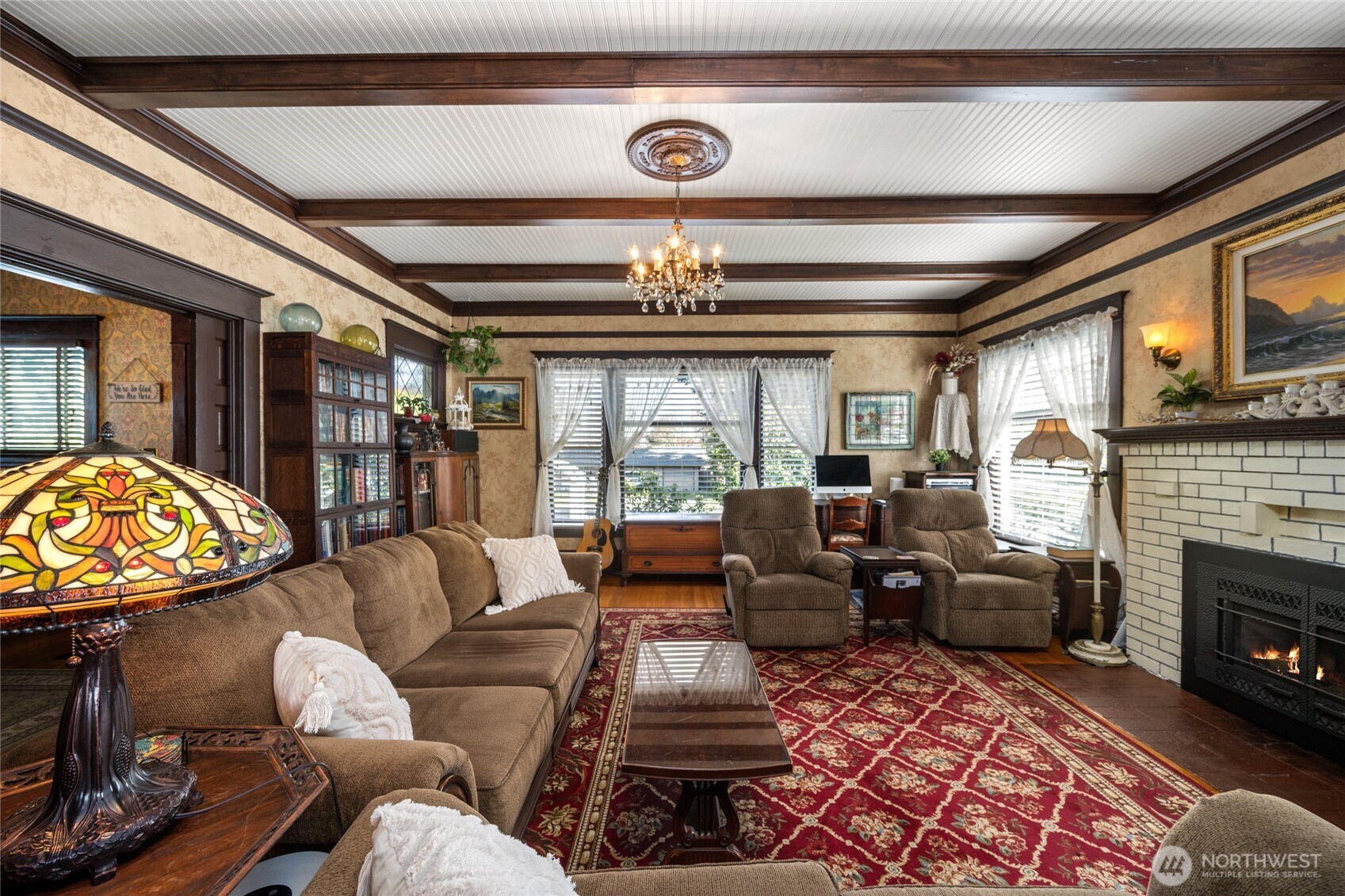 1507 15th Street Anacortes, WA 98221 - Photo 6 of 40 a living room with furniture a fireplace and a chandelier