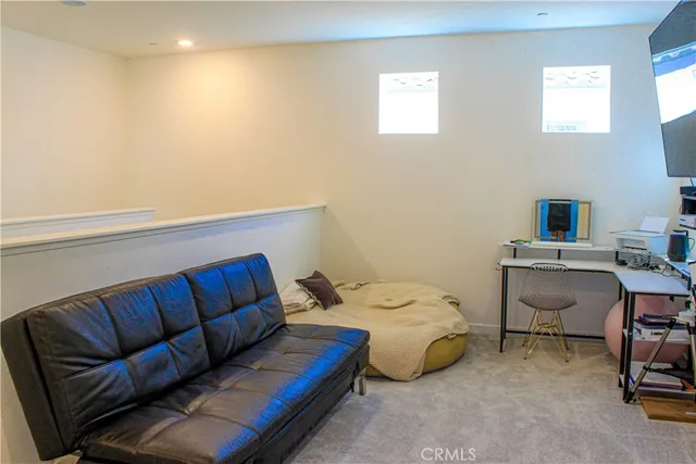 a bedroom with a bed and a lounge chair