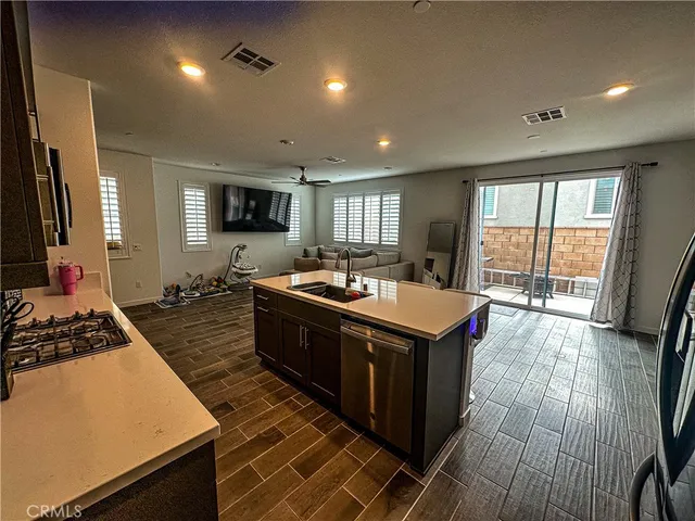 a kitchen with stainless steel appliances granite countertop a stove and a sink