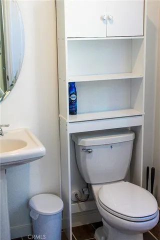 a bathroom with a toilet a sink and a mirror