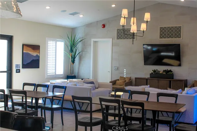 a view of a dining room with furniture and a flat screen tv