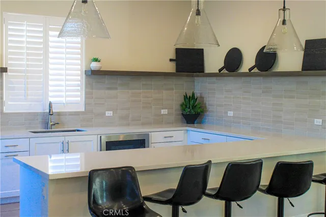 a kitchen with stainless steel appliances granite countertop a sink a stove and a microwave