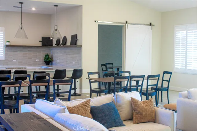 a living room with furniture wooden floor and a cabinet