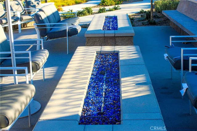 a view of a patio with table and chairs potted plants with wooden floor and fence