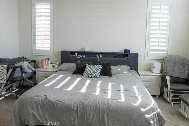 a bedroom with a bed and a chair