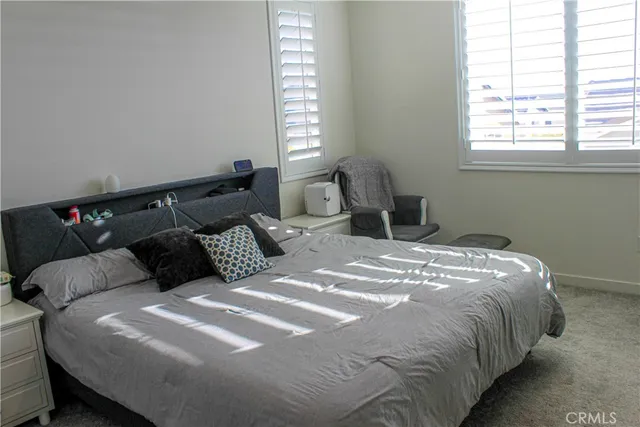 a bed sitting in a bedroom next to a window