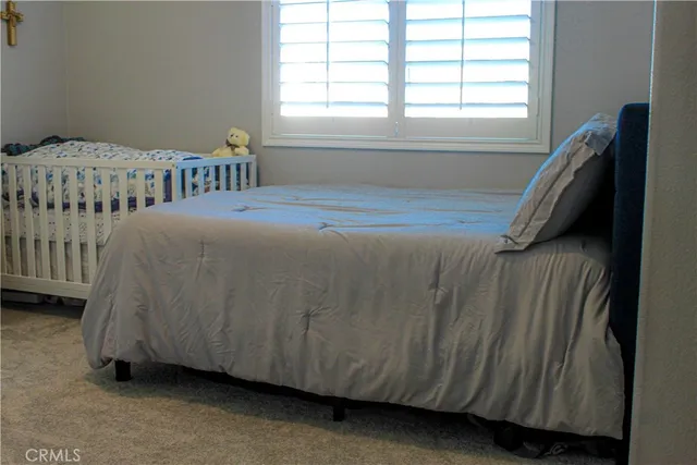 a bedroom with a bed and a window