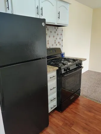 a stove top oven sitting inside of a kitchen