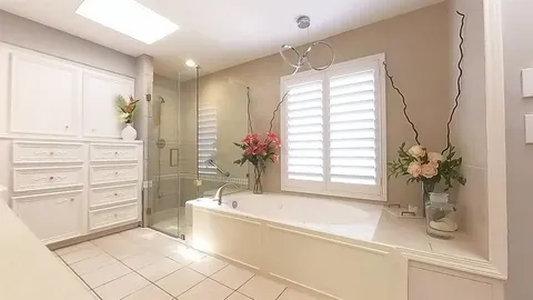 a bathroom with a tub sink and mirror