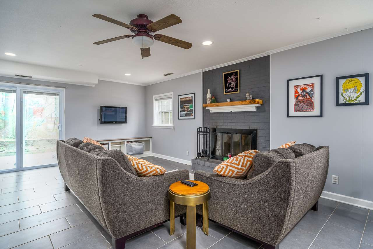 3223 Haddon Road Durham, NC 27705 - Photo 17 of 25 Basement family room with a woodburning firplace and lots of space for games, crafts, and activities. Family room