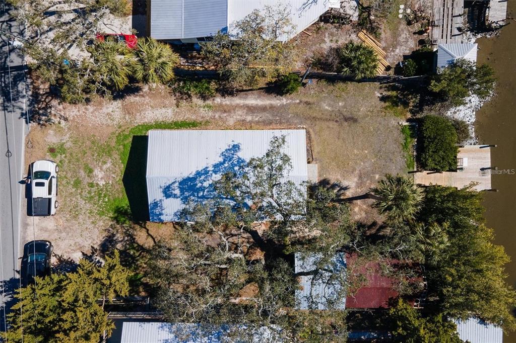 1170 Whiddon Avenue Cedar Key, FL 32625 - Photo 2 of 8 an aerial view of a house with a yard and lake view