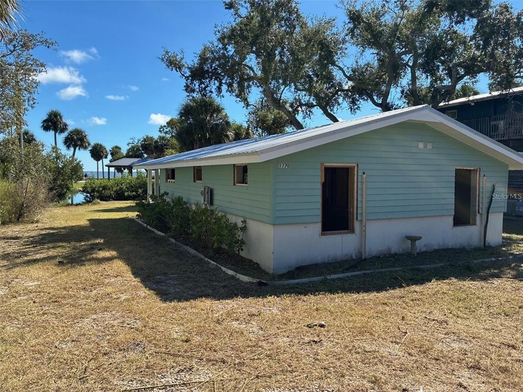 1170 Whiddon Avenue Cedar Key, FL 32625 - Photo 5 of 8 a backyard of a house with lots of green space