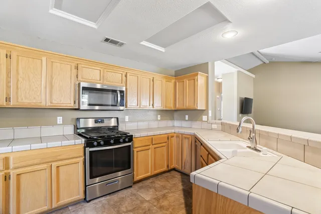 a kitchen with a sink stove and microwave