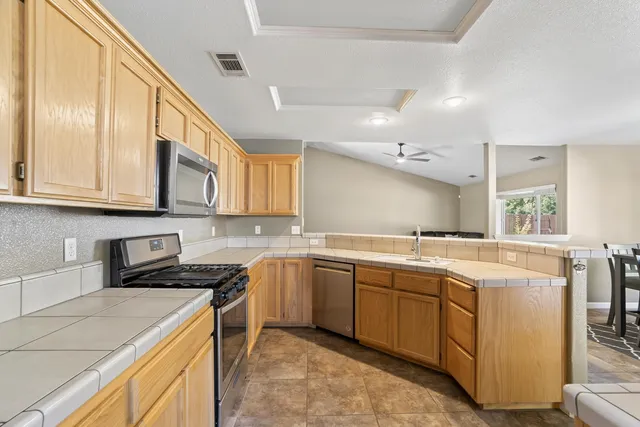 a kitchen with a sink stove and cabinets
