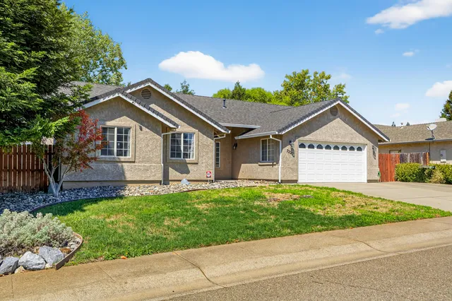 a view of a house with a yard and a garden