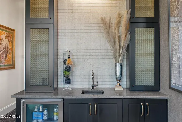 a kitchen with kitchen island granite countertop a table and chairs in it