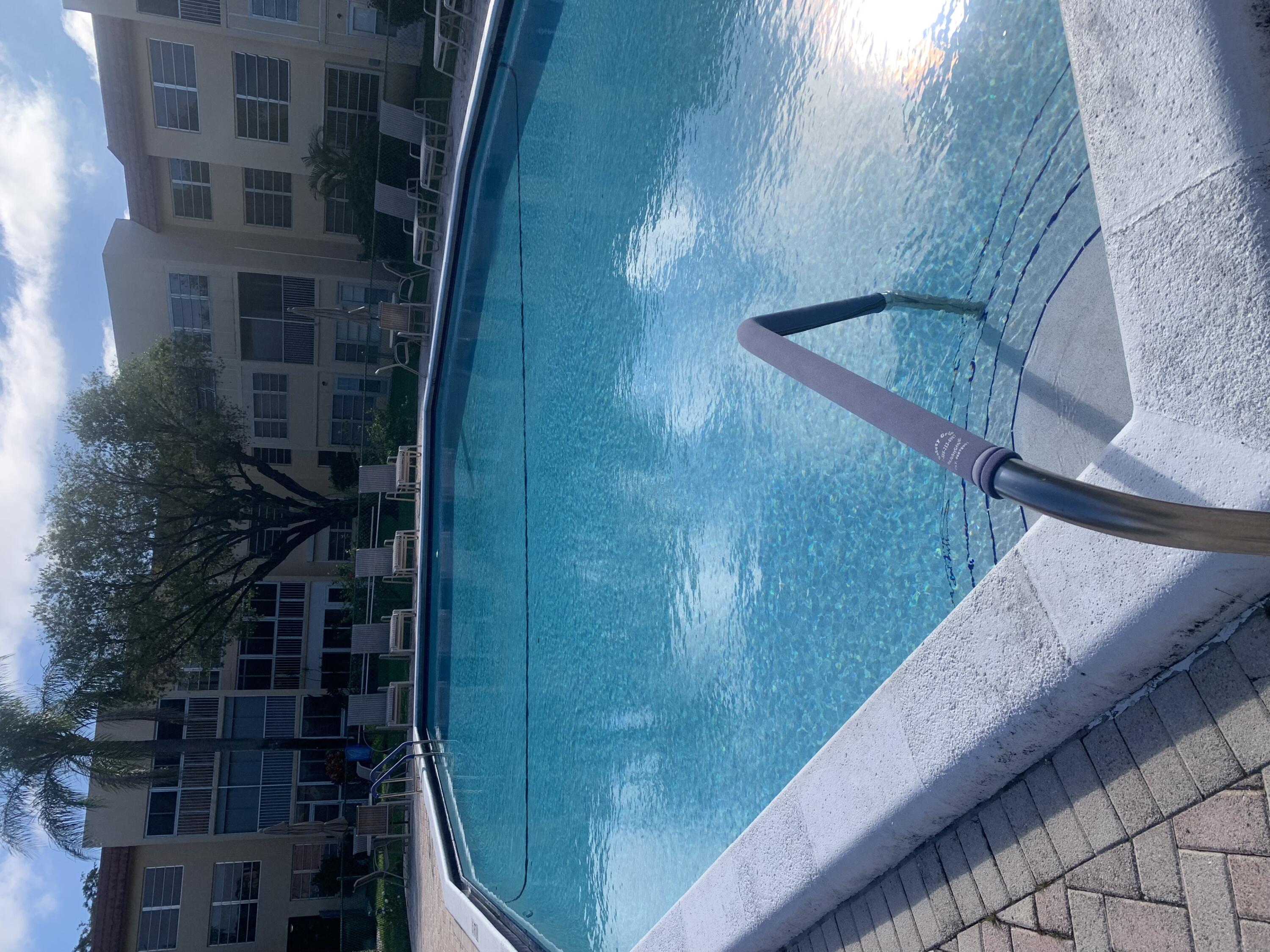 6850 Royal Palm Boulevard, Unit 104G Margate, FL 33063 - Photo 17 of 17 a view of a swimming pool with a yard and plants