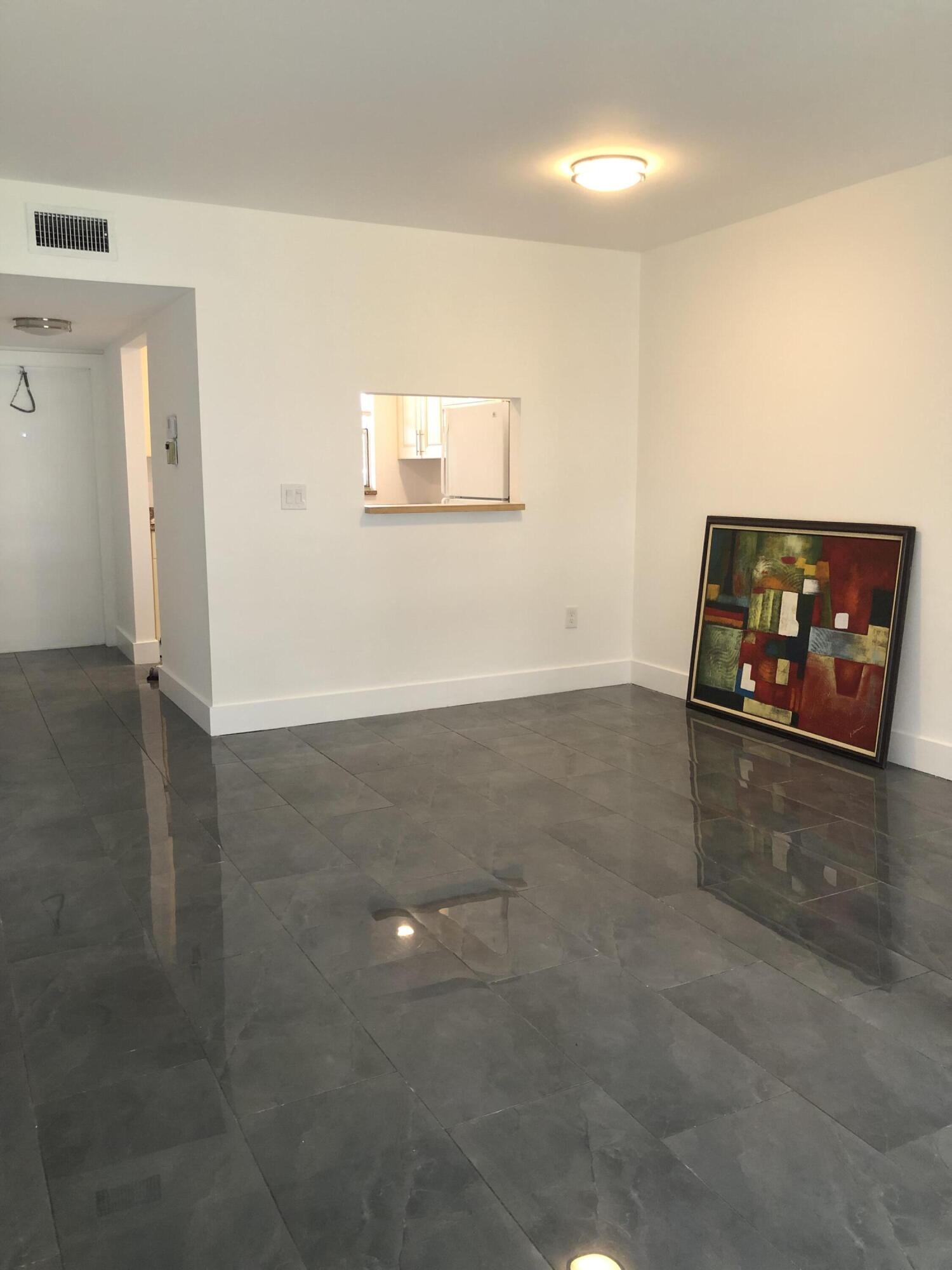 6850 Royal Palm Boulevard, Unit 104G Margate, FL 33063 - Photo 2 of 17 an empty room with wooden floor and windows