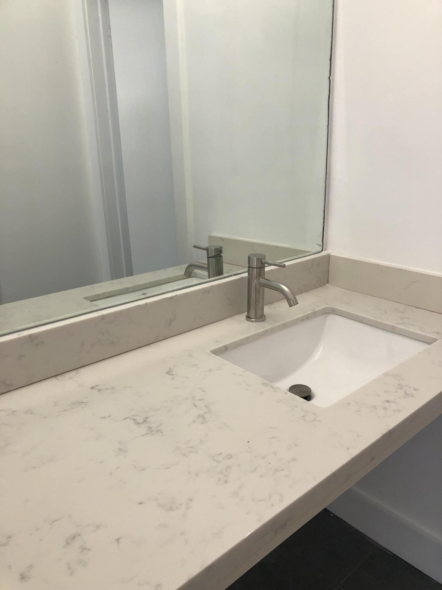 6850 Royal Palm Boulevard, Unit 104G Margate, FL 33063 - Photo 10 of 17 a bathroom with a sink and a tub