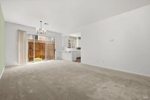 a view of a livingroom with furniture and a window
