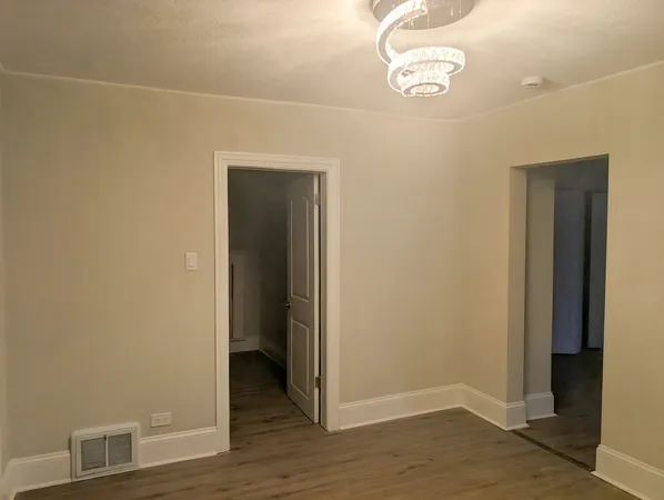 a view of a room with wooden floor
