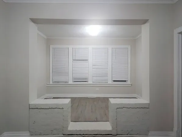 a bathroom with a window sink and cabinets