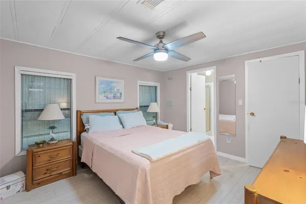 a bedroom with a large bed and a chandelier
