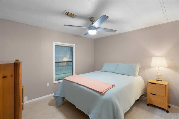 a bedroom with a bed and a lamp