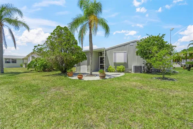 a view of a house with a backyard