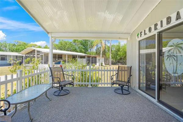 a view of a porch with furniture and garden