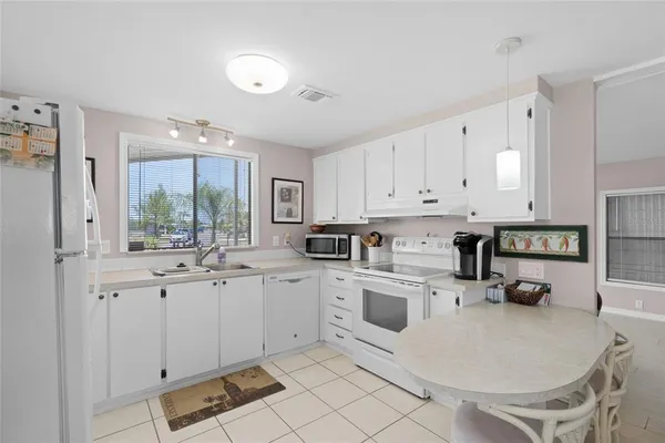a kitchen with sink cabinets and appliances