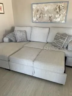 a living room with furniture and painting on the wall