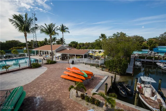 an aerial view of a house with swimming pool and sitting area