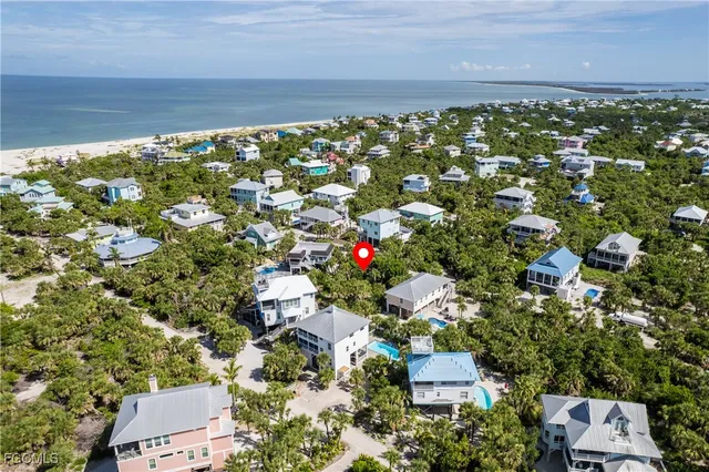 an aerial view of house with yard and mountain view in back