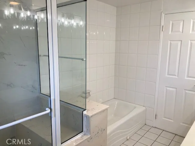 a bathroom with a bathtub and a shower
